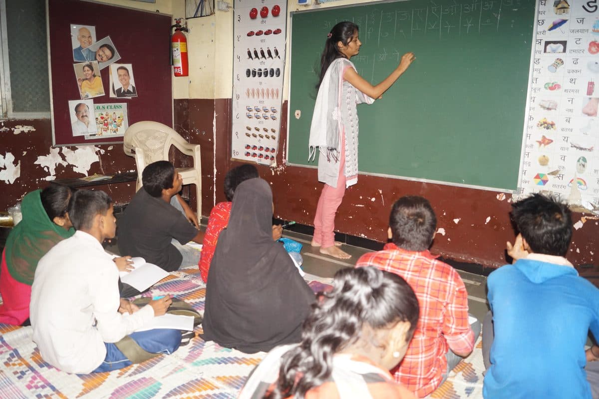 Teacher leading a literacy class at a Karunya Trust community classroom