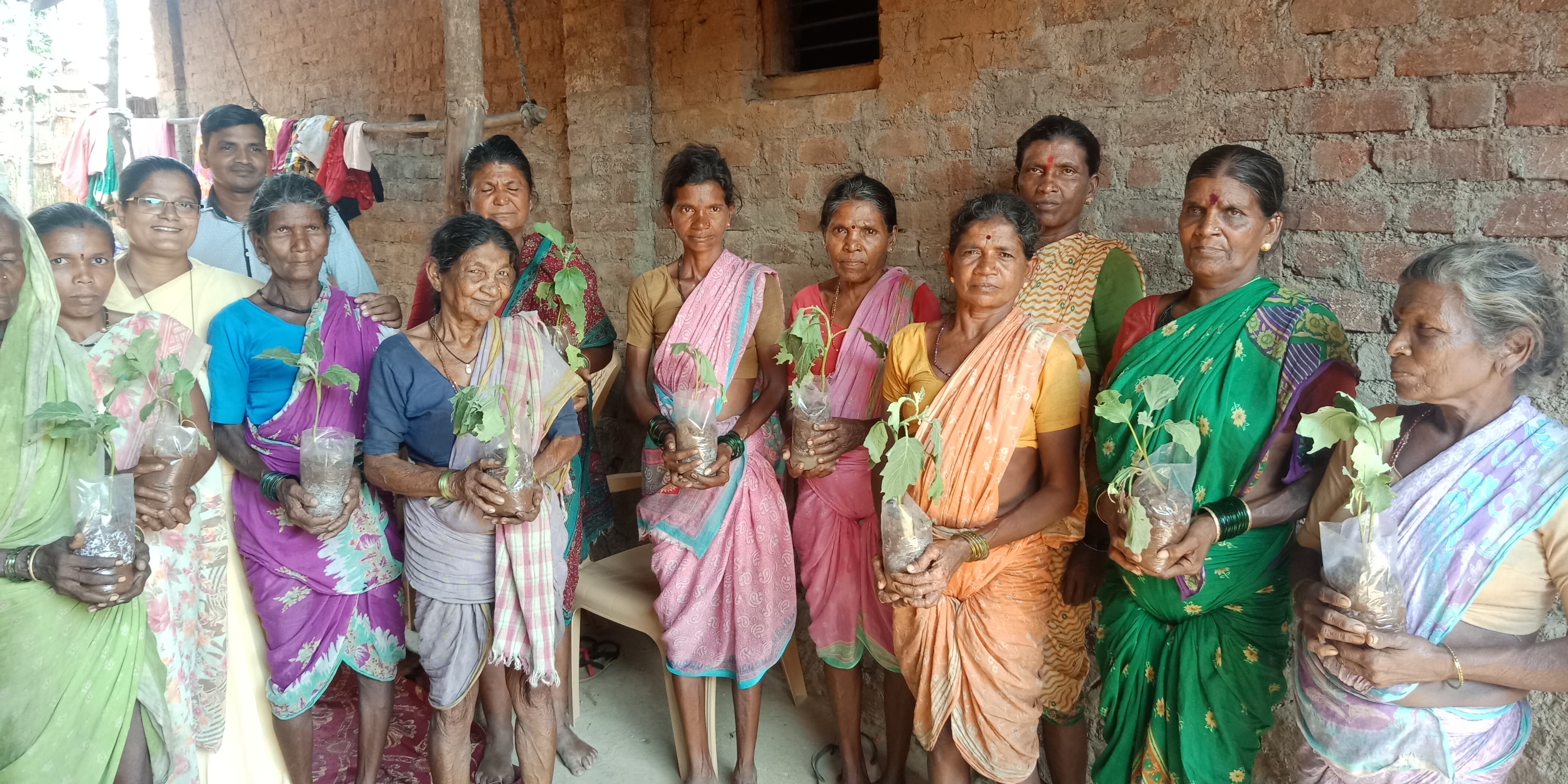 Karunya Trust community members with saplings