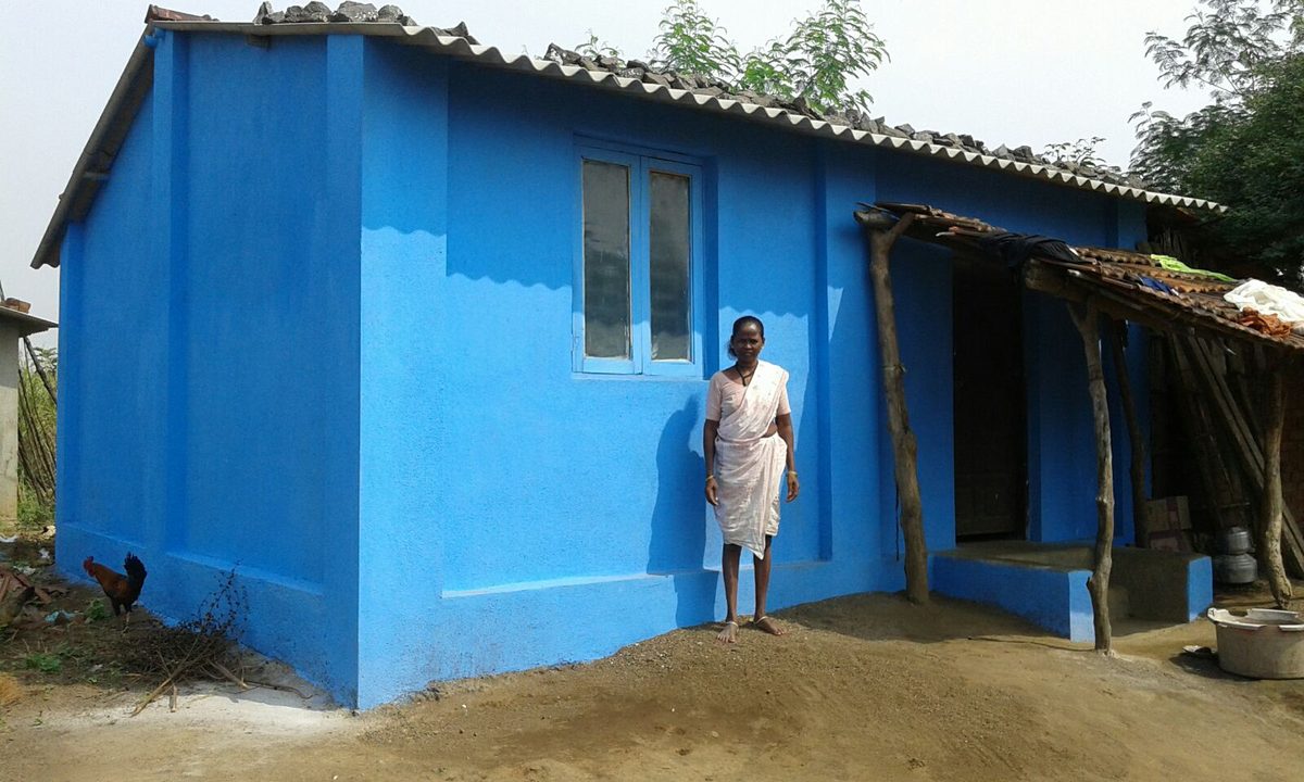 Woman standing outside her newly built home